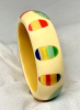 SZ93 Shultz custard bakelite bangle with laminated fingernail dots